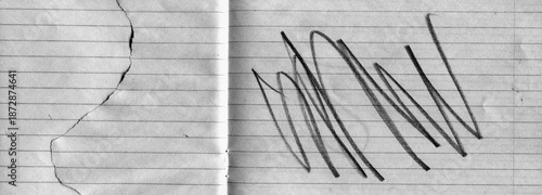 Lined notebook paper texture with fold crease, torn edge and black expressive pencil marks. Minimal yet emotional background combining stationery surface with abstract gesture and contrast