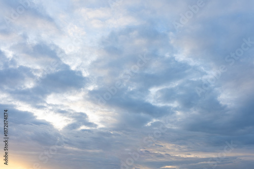 Overcast sky filled with dramatic blue and gray clouds during twilight hours