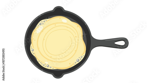 Golden pancake batter gently bubbling in a warm, rustic cast iron skillet. This detailed overhead view captures the inviting process of delicious