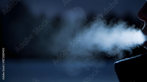 Visible warm breath exhaled into the freezing night air during cold weather