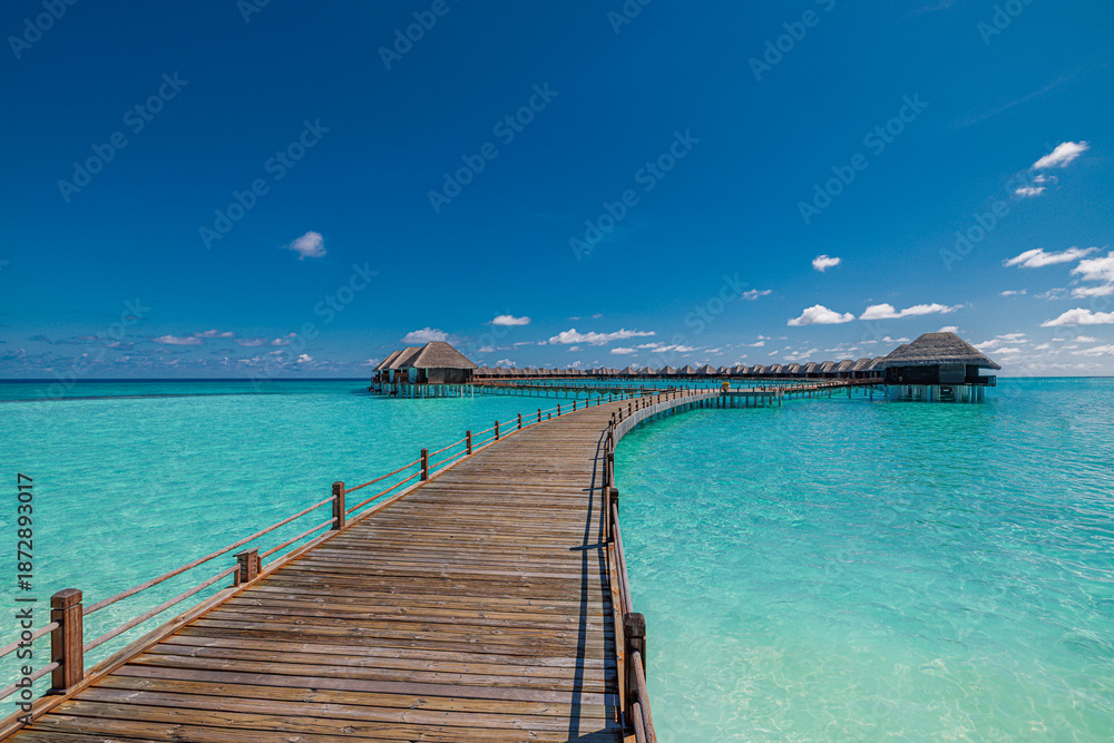 Obraz premium Tropical Maldives water villa wooden pier over pristine turquoise ocean lagoon aerial view luxury resort summer vacation travel destination paradise tropical island serene beach landscape background