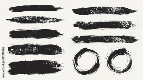 A collection of black brush stroke textures and circular ink marks on a light background.