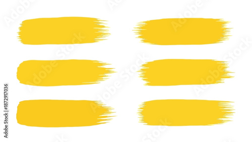 Six vibrant yellow brush stroke elements isolated on a white background, perfect for graphic design.
