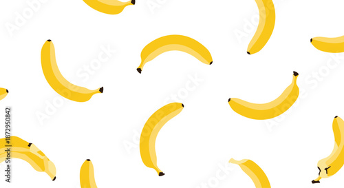 Tropical seamless pattern of bright yellow bananas scattered across a clean white background for healthy and summer designs.