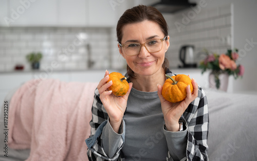 Girl In Glasses Holding Orange Small Pumpkins