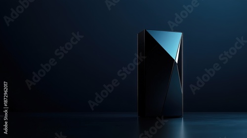 Sleek black geometric object illuminated against a dark background, showcasing modern design