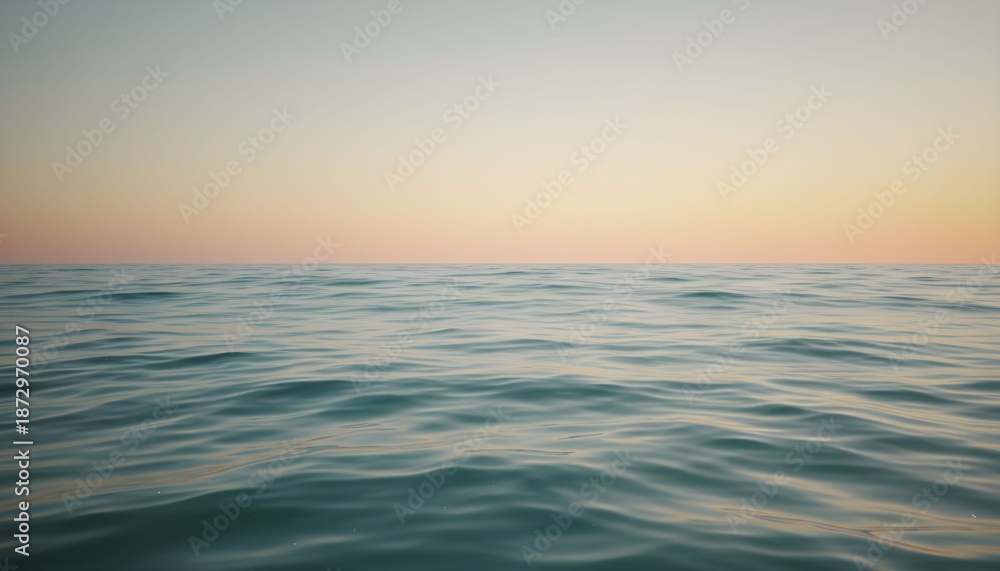 Obraz premium Calm ocean waves gently ripple at serene sunset on peaceful water surface
