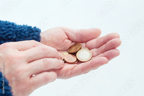 Euro coins in a woman's hands, selective focus.