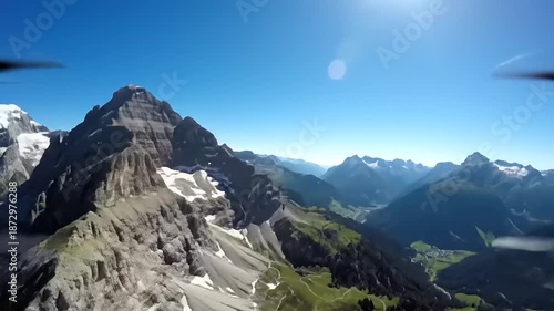 Majestic mountain peaks under clear blue sky aerial view landscape