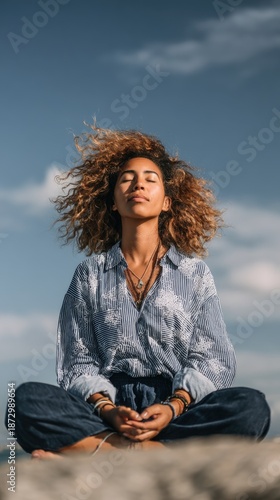 Woman practicing mindfulness on a rocky outcrop