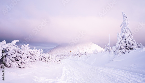 misty view on winter Karkonosze mountains during dusk