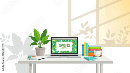 Cozy spring workspace with laptop and books on white desk