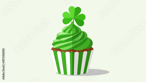 A green cupcake with shamrock decoration on top viewed from directly above