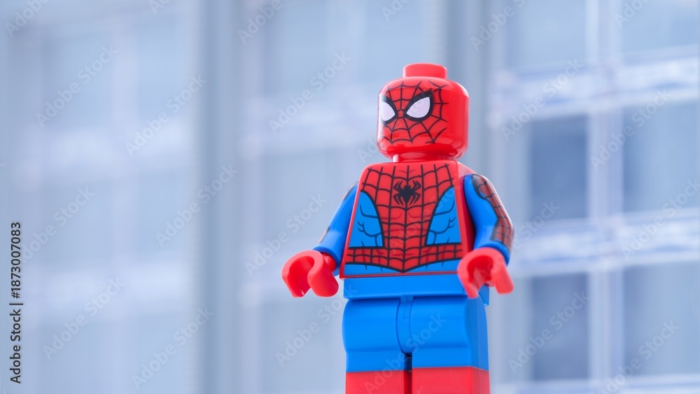 Fototapeta premium Tambov, Russian Federation - January 24, 2025 Lego Spiderman minifigure standing in front of an office building. Close-up