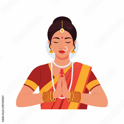 Elegant Indian woman in a vibrant sari, adorned with traditional jewelry, performing the Namaste gesture with closed eyes, symbolizing greeting, respect, and cultural tradition.