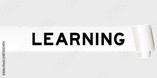 Ripped gray paper background that have word learning under torn part