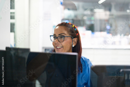 Experienced woman working on computer in office