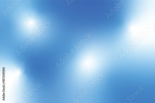 A blurred image predominantly features a gradient of light blue hues with soft out of focus light spots creating a