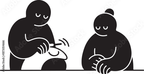 Two people sitting at a table with a piggy bank