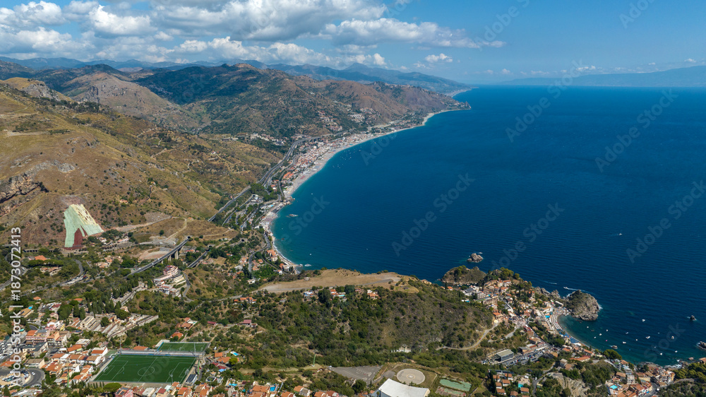 Obraz premium Aerial view of the long beach of Letojanni, in the province of Messina, Sicily, Italy. It's the eastern coast of Sicily, overlooking the Ionian Sea. The Nebrodi Mountains are to the side.