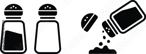 Black and white of salt and pepper shakers with pouring salt
