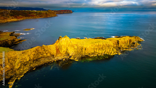 Drone view of Brothers Point on Isle of Skye, rugged coastline and cliffs under soft diffused light, calm sea and wide copy space, minimal travel landscape, iconic Scotland scenery