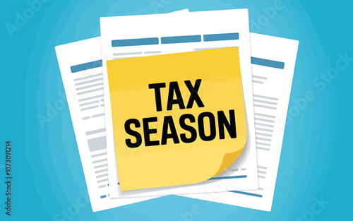 Tax season documents with yellow sticky note reminder