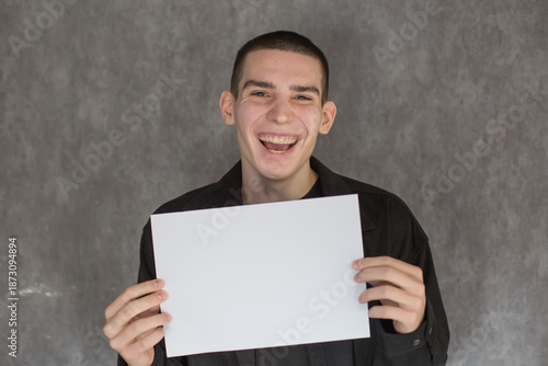Young Man Holding Blank White Sign for Your Message
