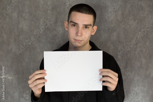 Young Man Holding Blank White Sign for Your Message