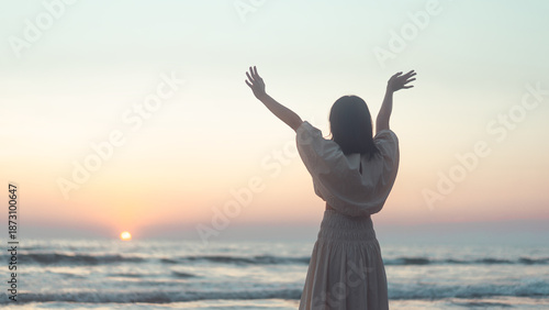 Fotografie Rear view of young adult woman stretching hand open arm hug relax on the beach s