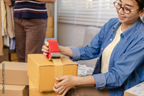 Photos Small business warehouse store, women workers apply shipping label on parcel and