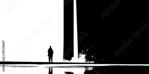 Silhouette of person by massive monolith with reflective water in high contrast scene