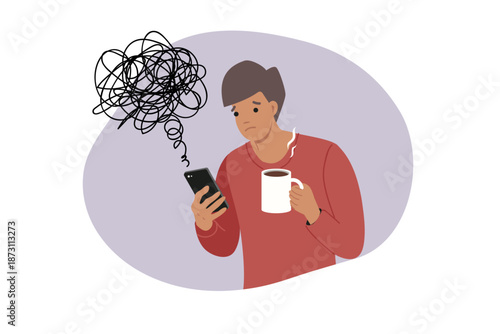 Man reads news on mobile phone, causing deterioration in mood and chaos in thoughts. Guy with mug of coffee and smartphone became victim of misinformation and propaganda on news sites.