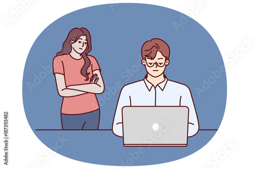 Frustrated woman near husband using laptop and suffering from internet addiction and working late into night. Concept of imbalance between internet career and family, causing resentment of loved ones