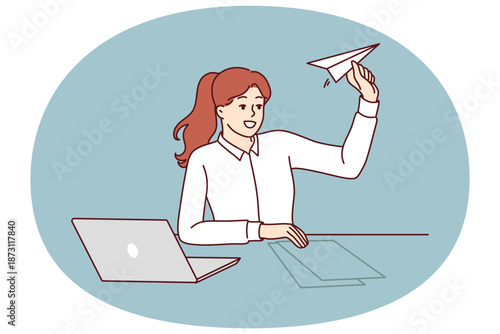 Woman office manager is distracted by launching paper plane and suffering from lack of motivation. Girl manager sits at table with laptop for metaphor of launching own successful startup