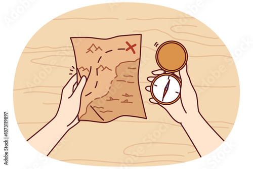 Treasure map and compass in hands of man looking for expensive jewels lost at sea from pirate vessels. Gold digger and adventurer in search of treasure or sunken ship explores ocean coast