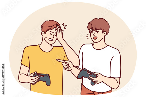 Men play video game and hold joysticks for computer or console during home esports tournament. Young guy gets upset after losing to friend in video game of virtual football or racing simulator
