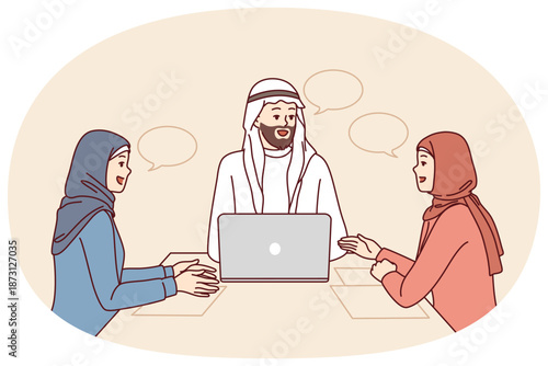 Corporate business meeting with people in arabic clothes and hijabs sitting at office table with laptop. Meeting company employees with partners for brainstorming and discussion of marketing strategy