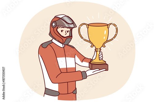 Man racer with golden cup for winning tournament rejoices at receiving championship title in competition. Guy driver, participant in extreme races on cars, demonstrates trophy of racer