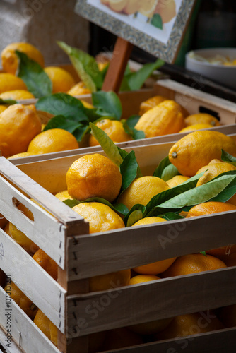 Limones in a wooden crate on the market place in Italy