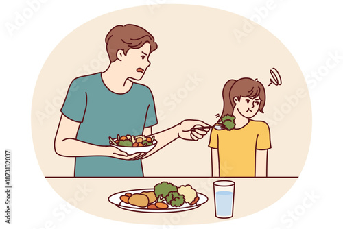 Child does not want to eat salad and green vegetables standing near father trying to teach daughter eat healthy food. Stubborn teenage girl refuses healthy vegetables and turns away.