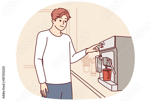 Man uses coffee machine standing in kitchen of apartment, preparing drink for invigorating breakfast. Guy makes hot coffee during work break to get rid of drowsiness and be more productive