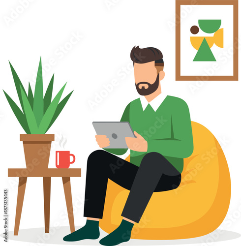 Man sitting on a yellow bean bag using a digital tablet at home