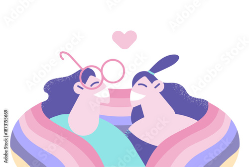 Happy lesbian couple covered in LGBT flag