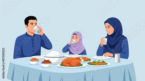 Family enjoys meal together, drinking and eating various dishes at a round table with a blue tablecloth