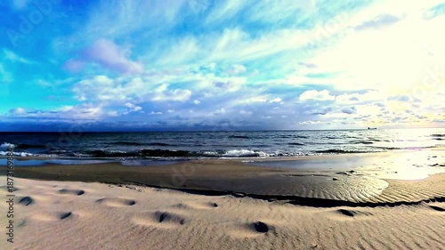 Calm Ocean Shoreline at Sunset with Soft Waves and Cloudy Sky