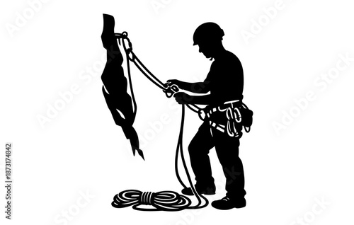 Silhouette of a male rock climber with gear in action