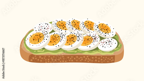Delicious slice of avocado toast topped with numerous slices of hard boiled eggs seasoned with black pepper for a healthy breakfast or brunch meal.