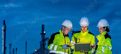 Fényképezés Petrochemical industry night engineer teamwork working on laptop Team of Petrole