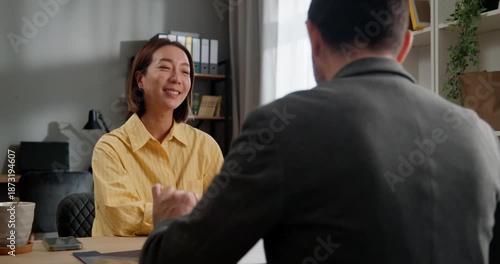 Businesswoman having meeting with client in office and signing contract